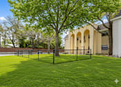 Thumbnail 32 of 42 - A tree stands in a grassy yard in front of a building. at The Flats at Seminole Heights, Tampa, Florida