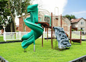Thumbnail 66 of 67 - A green and blue slide in a playground.