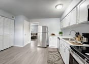 Thumbnail 5 of 42 - A kitchen with white cabinets and a stainless steel refrigerator. at The Flats at Seminole Heights, Tampa, Florida