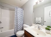 Thumbnail 38 of 66 - A white bathroom with a toilet, sink, and shower. at Willowbrooke Apartments & Townhomes, Brockport, NY