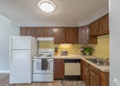 Thumbnail 7 of 17 - A kitchen with a white refrigerator, white stove, and white oven.