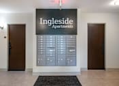 Thumbnail 20 of 29 - A wall of mailboxes is in front of a sign that says Ingleside Apartments.