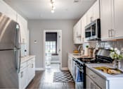Thumbnail 5 of 29 - A kitchen with a stainless steel refrigerator and a stainless steel stove.