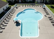 Thumbnail 64 of 67 - A large outdoor swimming pool surrounded by lounge chairs.