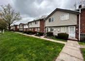 Thumbnail 37 of 61 - a row of houses on a cloudy day at Highview Manor Apartments, Fairport, NY, 14450