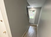 Thumbnail 23 of 61 - a view down the hallway from the top of the stairs at Highview Manor Apartments, Fairport, NY, 14450
