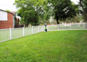 Thumbnail 34 of 61 - a yard with a white picket fence and a fire hydrant