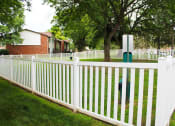 Thumbnail 35 of 61 - a white picket fence with a tree in the background