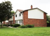 Thumbnail 53 of 61 - a row of houses with a green lawn in front of them