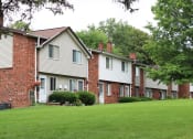 Thumbnail 43 of 61 - a row of houses on a green lawn
