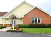 Thumbnail 25 of 61 - the front of a house with a lawn and flower beds