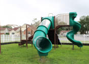 Thumbnail 28 of 61 - a playground with a large green slide