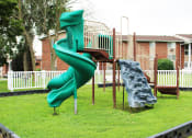 Thumbnail 29 of 61 - a playground with a slide and climbing equipment