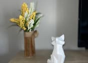 Thumbnail 6 of 111 - A white ceramic fox figurine sits on a wooden surface next to a vase with yellow flowers