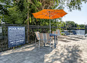 Thumbnail 31 of 47 - A pool area with a sign that says "No Diving" and an orange umbrella.