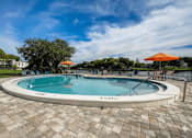 Thumbnail 32 of 47 - A round pool with a brick pattern around it.