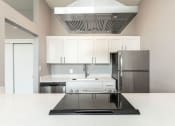 Thumbnail 9 of 47 - a kitchen with white cabinets and stainless steel appliances