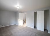 Thumbnail 34 of 103 - an empty living room with white doors and a carpet floor at Willowbrooke Apartments, Brockport, 14420
