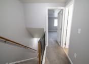 Thumbnail 33 of 103 - view from the top of the stairs looking down into the hallway and into the bedroom at Willowbrooke Apartments, New York