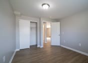 Thumbnail 74 of 103 - an empty living room with wood flooring and white doors at Willowbrooke Apartments, Brockport, 14420