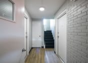 Thumbnail 86 of 103 - a hallway with white walls and a staircase with a white door at Willowbrooke Apartments, Brockport, NY