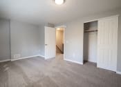 Thumbnail 53 of 103 - an empty living room with a door to a closet at Willowbrooke Apartments, Brockport