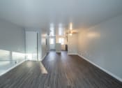 Thumbnail 38 of 103 - a living room and dining room with wood floors and white walls at Willowbrooke Apartments, New York