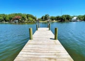 Thumbnail 20 of 47 - a dock on a lake with a house in the background