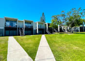 Thumbnail 36 of 47 - a row of houses with a grassy yard in front of them