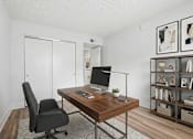 Thumbnail 19 of 58 - Home office with wooden desk and shelving at The Residences at Soho Apartments, Tampa, FL