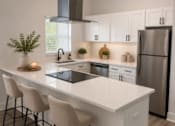 Thumbnail 9 of 53 - A modern kitchen with a white island and stainless steel appliances.