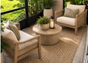 Thumbnail 16 of 53 - A patio with a couch, table, and a view of a lake.
