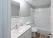 Thumbnail 8 of 15 - a bathroom with a sink toilet and a shower