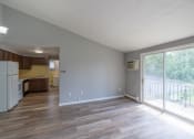 Thumbnail 4 of 15 - an empty living room and kitchen with a sliding glass door