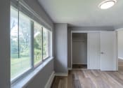 Thumbnail 3 of 15 - an empty room with a large window and a white door