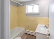 Thumbnail 9 of 15 - an empty bathroom with a sink toilet and tub