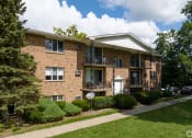 Thumbnail 12 of 15 - the exterior of a brick apartment building with a sidewalk