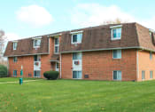Thumbnail 90 of 103 - a red brick apartment building with a green lawn at Willowbrooke Apartments, New York