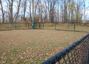 Thumbnail 100 of 103 - a dog park with a fence and a bench at Willowbrooke Apartments, Brockport, New York