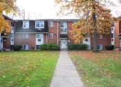 Thumbnail 92 of 103 - an apartment building with a sidewalk and a tree in front of it at Willowbrooke Apartments, Brockport, 14420