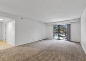 Thumbnail 7 of 49 - a bedroom with a sliding glass door and a carpeted floor