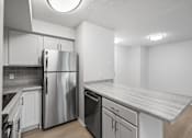 Thumbnail 14 of 26 - a kitchen with white cabinets and a stainless steel refrigerator
