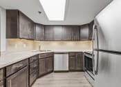Thumbnail 5 of 49 - a kitchen with dark wood cabinets and white appliances