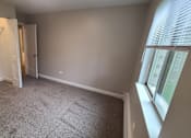 Thumbnail 33 of 48 - an empty room with a closet and a window