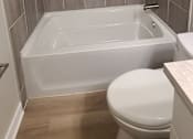 Thumbnail 34 of 48 - a small bathroom with a toilet and a bath tub
