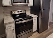 Thumbnail 19 of 48 - a kitchen with stainless steel appliances and white cabinets
