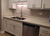 Thumbnail 18 of 48 - Rehabbed kitchen with white cabinets and glass backsplash