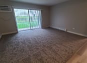 Thumbnail 37 of 48 - an empty living room with a sliding glass door