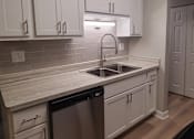 Thumbnail 39 of 48 - an empty kitchen with white cabinets and a sink