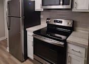 Thumbnail 40 of 48 - a kitchen with stainless steel appliances and white cabinets